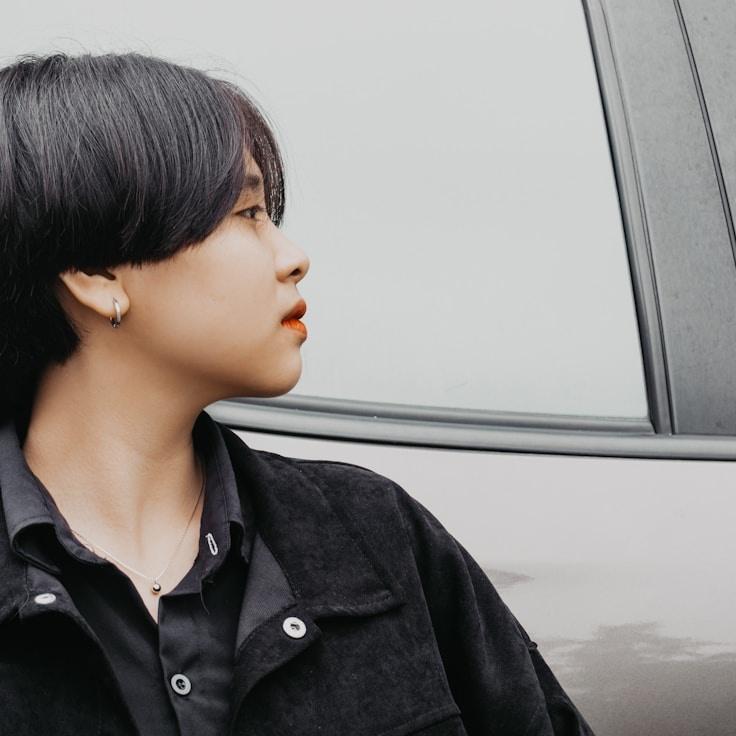 Alex Morgan, Lead Design Curator at SproutsAbleHarvest, reviewing corporate floral arrangements